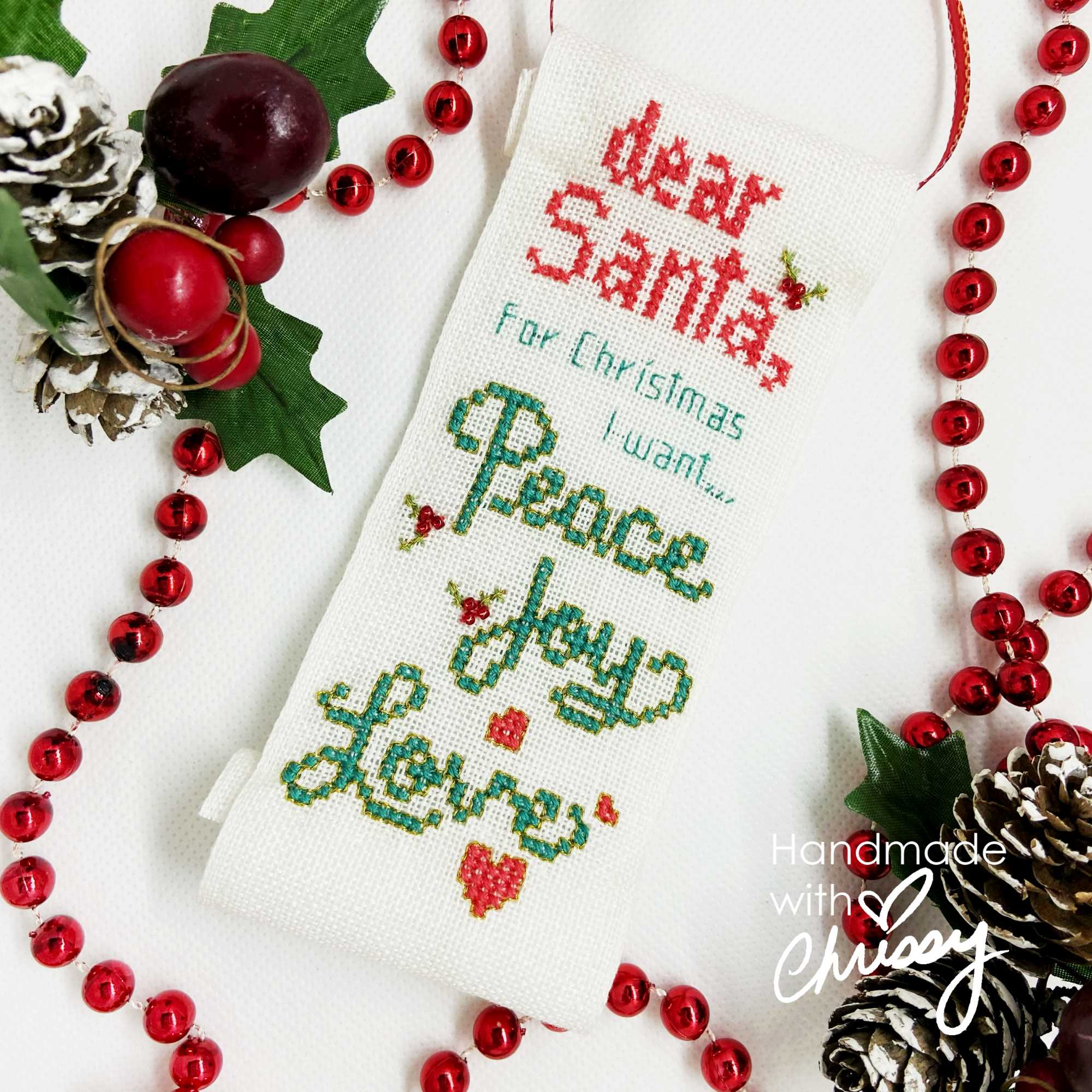 Dear Santa, Christmas Cross Stitch pattern by Chrissy Habblett of Handmade with Chrissy, finished as an ornament in a scroll shape