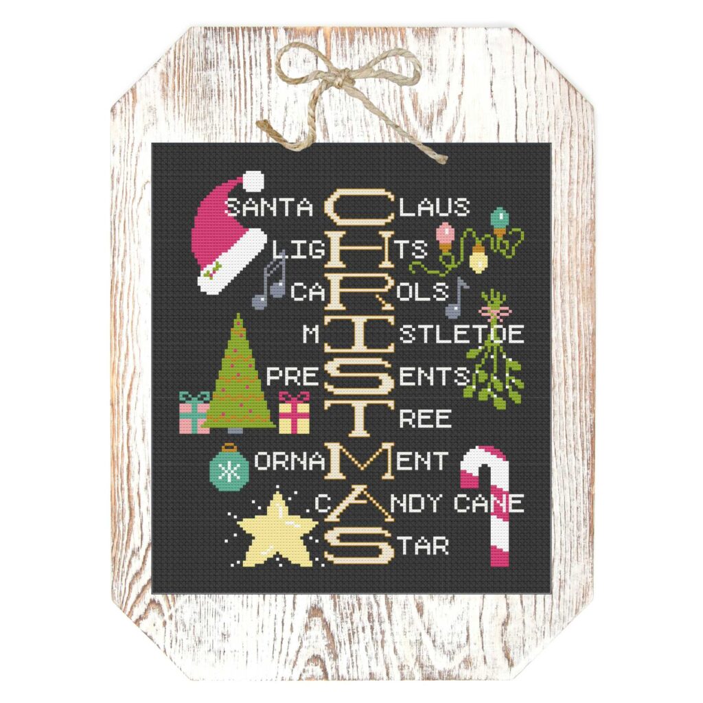 Christmas Cross-Stitch pattern, How do you spell Christmas, by Handmade with Chrissy finished on a white washed wood plaque.