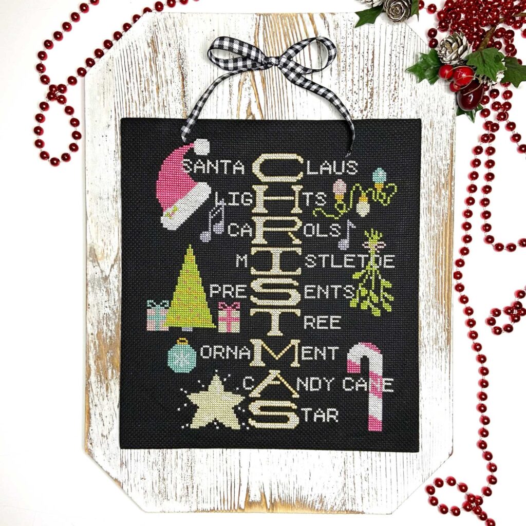 How Do You Spell Christmas, Christmas Cross Stitch pattern by Chrissy Habblett of Handmade with Chrissy, finished flat and mounted on a white washed wood plaque